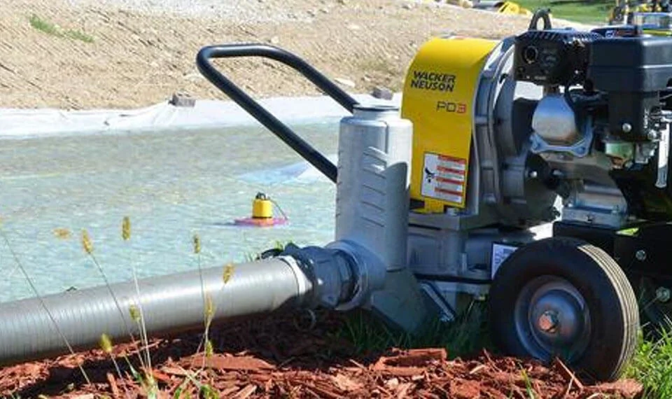 A gas diaphragm pump in use at a work site.