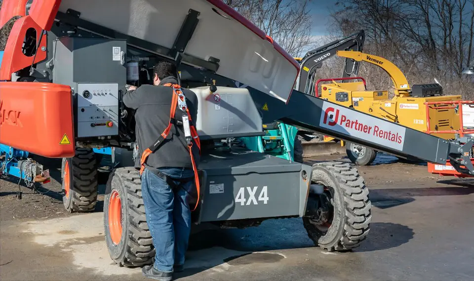 A photo of an employee servicing a piece of rental equipment.