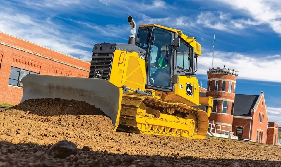 A photo of a bulldozer in use as it moves dirt.