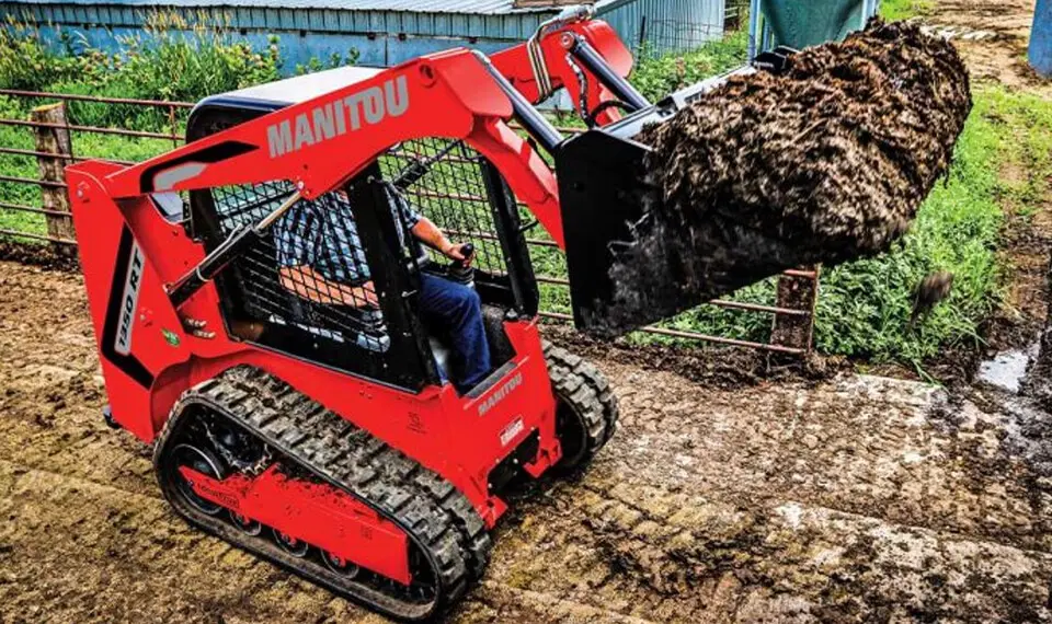 A photo of a skid steer being used to move soil.