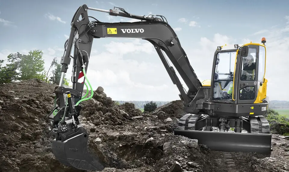 A photo of a track excavator moving soil on a job site.