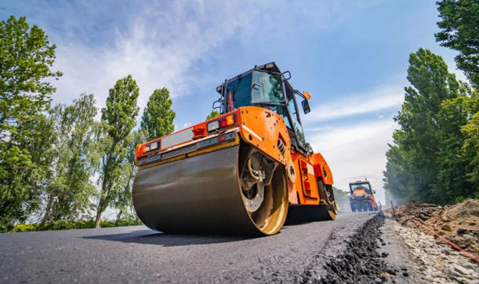 An asphalt roller in use on a newly blacktopped roadway