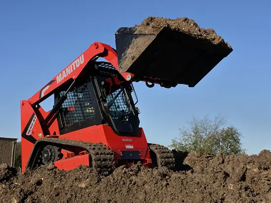 A photo of a skidsteer moving dirt