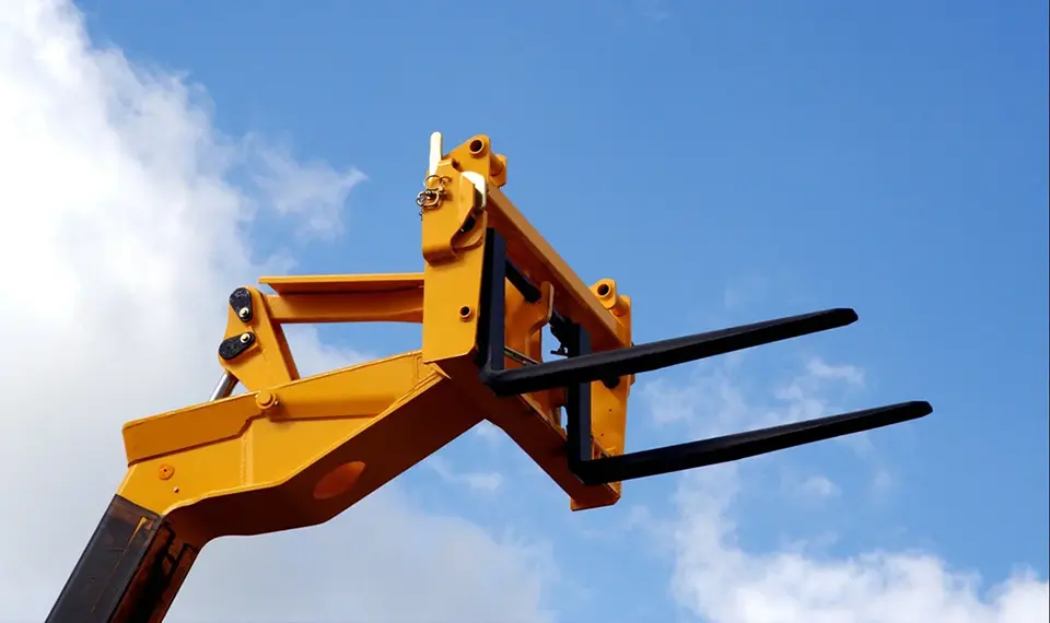 A reach forklift with its forks elevated.