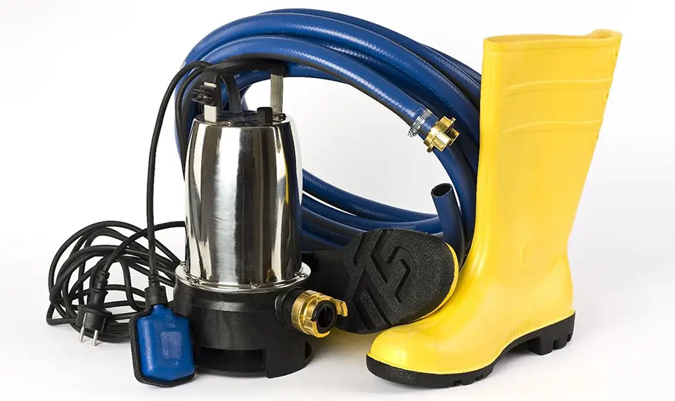 A submersible pump with a hose and a rubber boot.